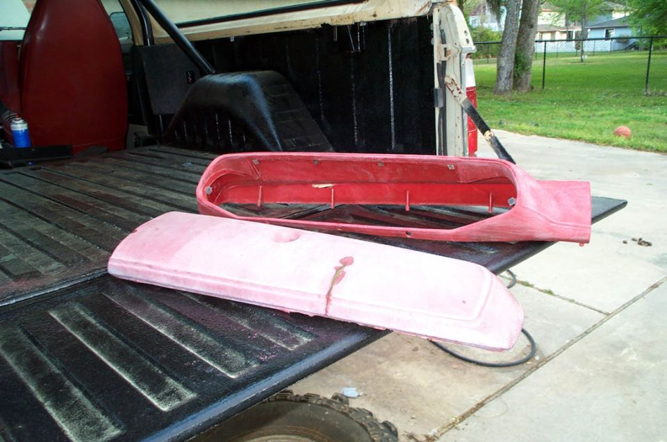 Truck bed with red and pink automotive parts