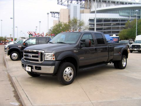 2000 Ford Crown Victoria - Dark gray Ford F-350 Super Duty crew cab pickup truck parked in front of a stadium.