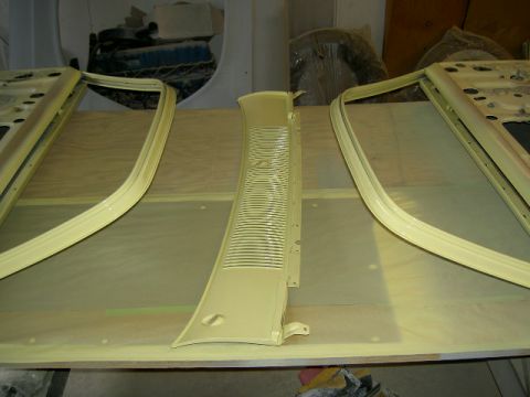 1967 Ford Ranchero - Car parts, including doors and a vent trim piece, are laid out on a surface, likely for painting or repair.