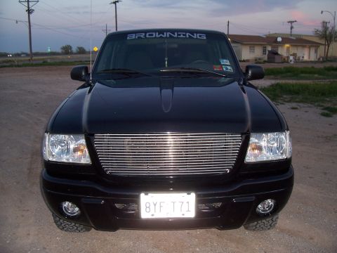 2003 Ford Ranger - Front view of a black 2003 Ford Ranger pickup truck a chrome grille and a Browning decal on the windshield.