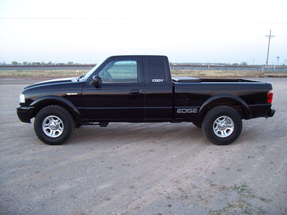Black 2003 Ford Ranger Edge pickup truck, side view