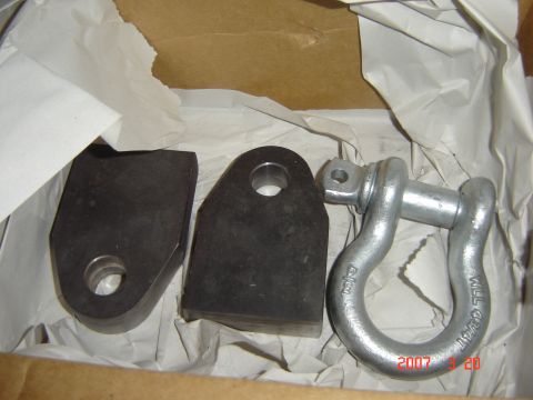 1993 Ford Bronco - Tow hitch receiver shackle mounts and a shackle are shown in a cardboard box.