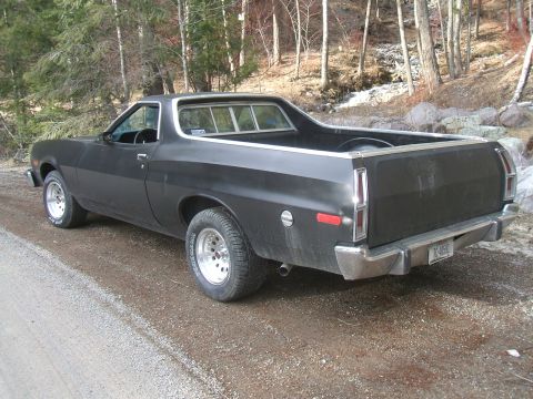 1974 Ford Ranchero - This 1972 Ford Ranchero is seen from a rear three-quarter view, parked on a gravel road surrounded by trees.