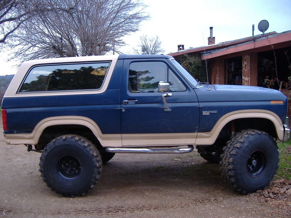 1986 Ford Bronco, blue with tan top and trim, lifted with large tires