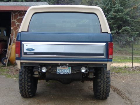1986 Ford Bronco - The rear of a Ford Bronco shows its taillights, spare tire carrier, and a license plate from Placerville, CA.
