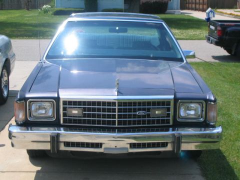 1999 Mercury Grand Marquis - Front view of a blue sedan, likely a 1979 Ford LTD, with a prominent chrome grille and square headlights.