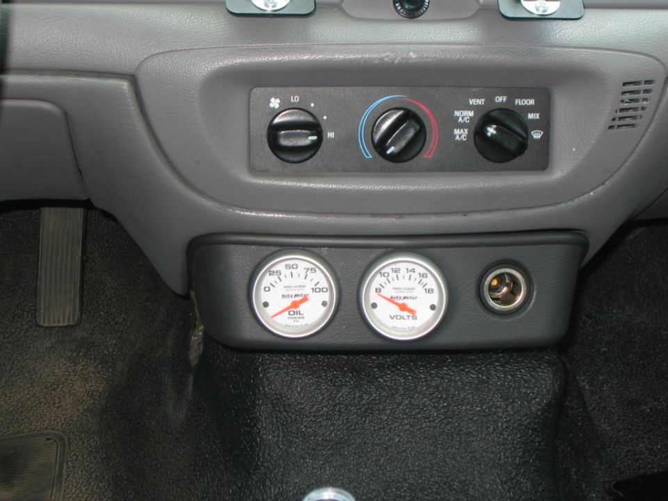 Lower dash HVAC controls with aftermarket Auto Meter oil pressure and volts gauges