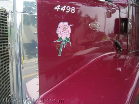 1968 Ford Mustang - Close-up of a Peterbilt truck's fender shows a decorative rose decal and identification numbers.