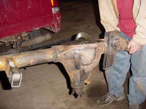 1992 Ford Bronco - A person holds a rear axle differential, revealing its internal gears.