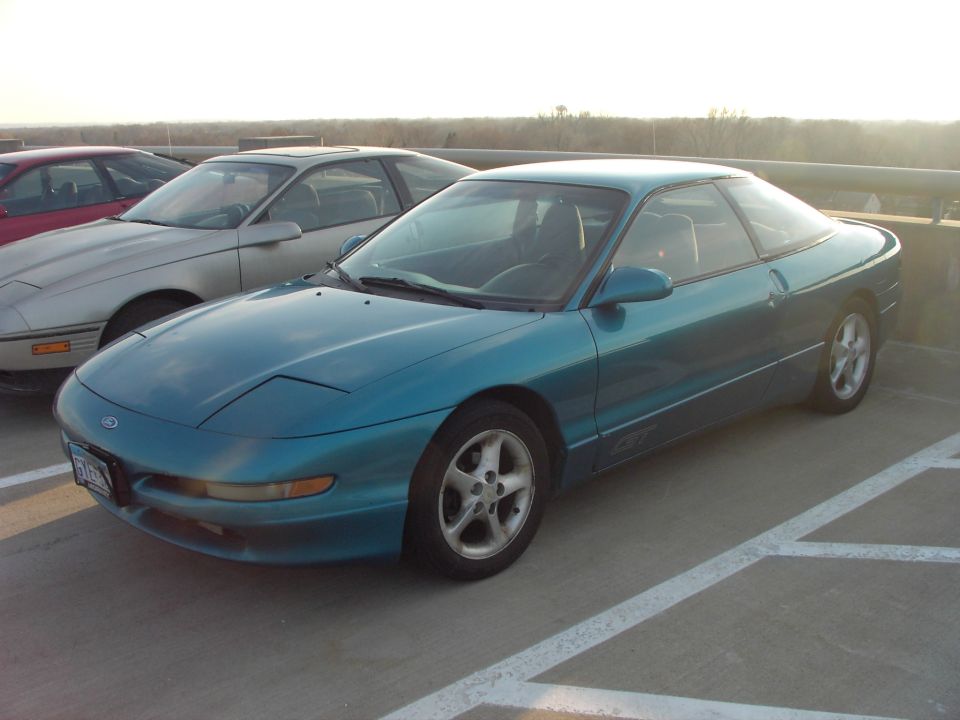 Teal 1989 Ford Probe coupe parked next to a silver car