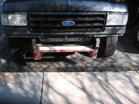 1991 Ford Bronco - The front grille and headlights are consistent with a 1991 Ford Bronco, a prominent Ford emblem and a custom bumper.