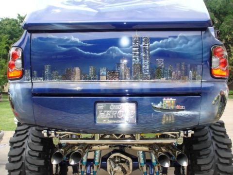 1995 Ford Crown Victoria - This modified pickup truck features a custom airbrushed mural on its tailgate depicting the New York City skyline.