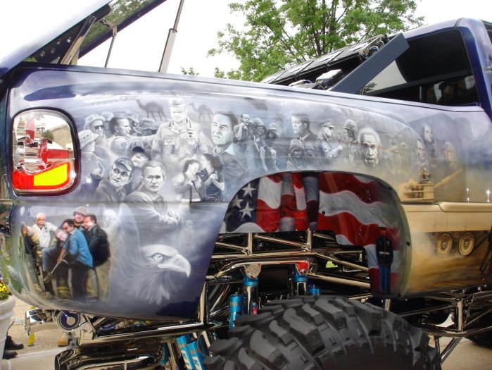 Truck bed airbrushed with portraits of historical figures and an American flag mural