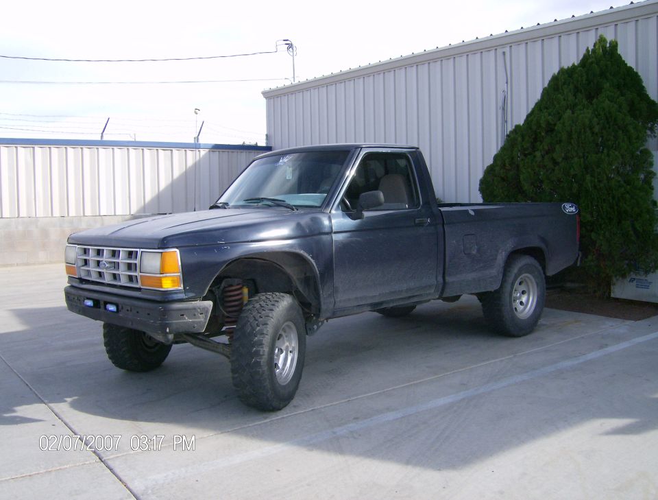 Dark blue 1991 Ford Ranger pickup truck parked outside a building