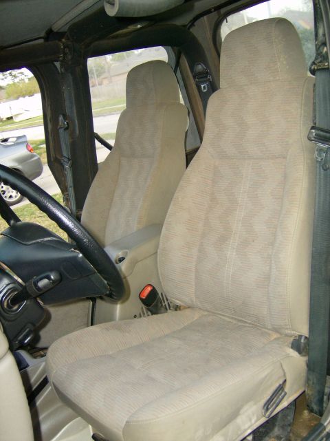 2004 Jeep Wrangler - Interior view of a 2004 Jeep Wrangler, highlighting the front seating area and dashboard components.
