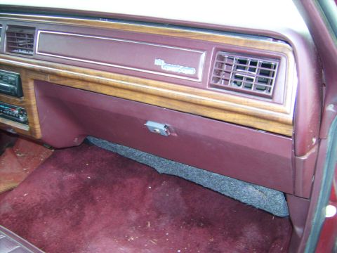 1982 Ford LTD Crown Victoria - Interior view of a 1982 Ford Crown Victoria LTD dashboard, showing the radio and wood grain accents.