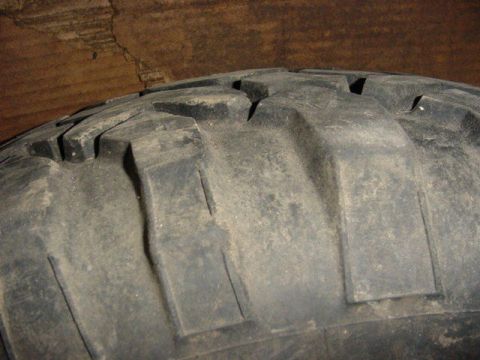1992 Ford Bronco - A close-up view of a tire's tread shows its aggressive block pattern and deep grooves.