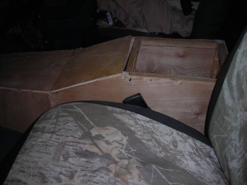 1994 Ford Bronco - A custom wooden console box is installed in the interior of a vehicle, partially obscuring a camouflage seat cover.
