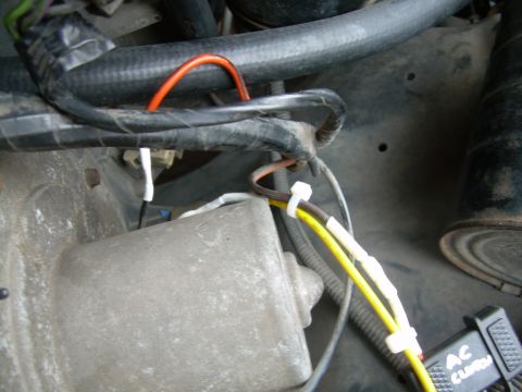 1988 Ford Bronco - This image shows a close-up view of a vehicle's electrical wiring and some engine components.