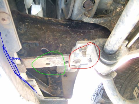 1991 Ford Bronco - This photo shows the underside of a vehicle, focusing on the frame and suspension components, with markings indicating specific parts.