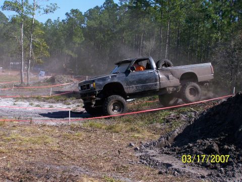 1989 Ford Bronco - A modified pickup truck navigates a challenging off-road course.