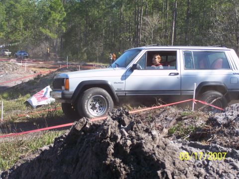 1989 Ford Bronco - A Jeep Cherokee navigates a muddy off-road track during an event in 2007.