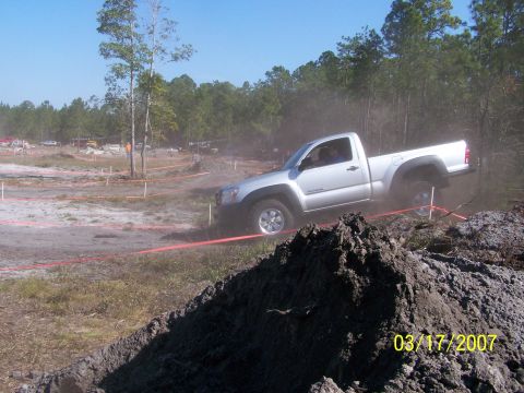 1989 Ford Bronco - A silver pickup truck navigates a dirt track during an event on March 17, 2007.