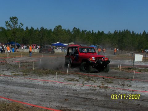 1989 Ford Bronco - A red Jeep Wrangler navigates a dusty off-road course during an event in 2007.
