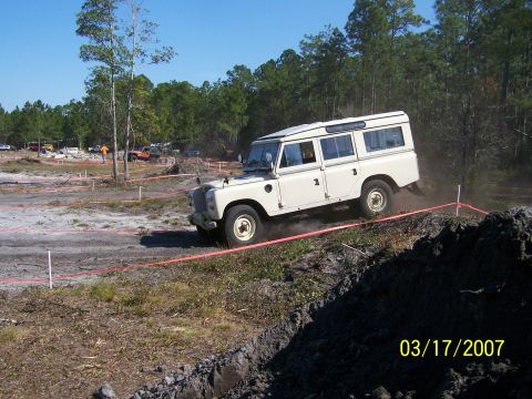 1989 Ford Bronco - A white Land Rover Defender 110 navigates a challenging off-road course during an event on March 17, 2007.
