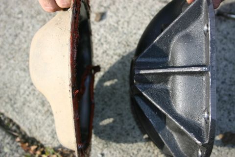 2003 Jeep TJ - A differential cover and its gasket are shown, with sealant visible on the cover's edge.