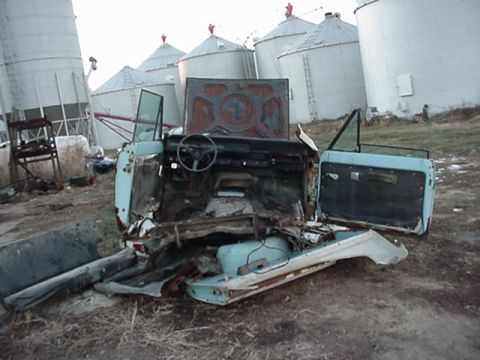 1992 Ford Bronco - This heavily damaged SUV's interior is exposed, with doors ajar and the hood open.