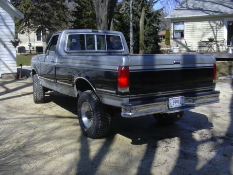 1992 Ford F-250 - Rear view of a two-tone 1992 Ford F-250 pickup truck with a lifted suspension.