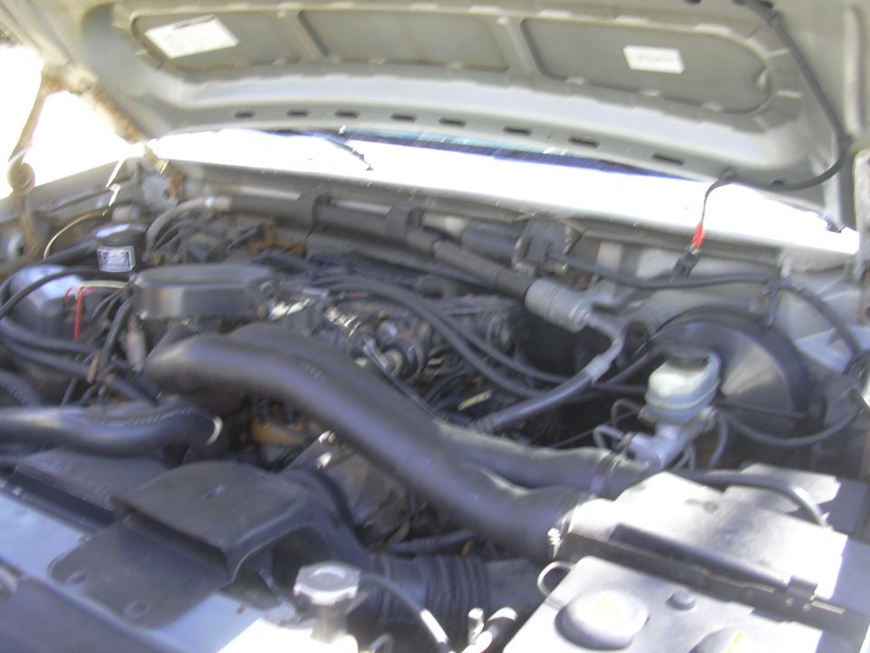 Engine bay with large black intake tube and brake fluid reservoir