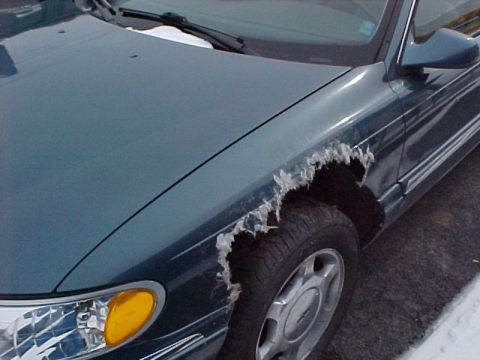 1978 Ford Mustang II - This teal car shows significant rust and damage to the front fender, exposing the tire.