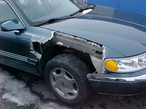 1978 Ford Mustang II - Car with significant damage to the front fender and wheel area.