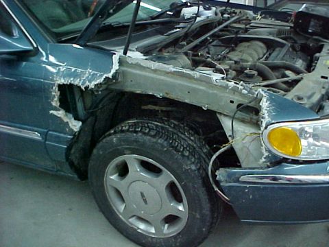 1978 Ford Mustang II - A damaged teal car is shown with its hood open, revealing the engine and a broken front fender.