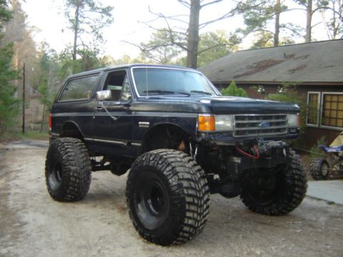 1989 Ford Bronco - This heavily modified 1989 Ford Bronco features a significant lift and massive tires for off-road capability.