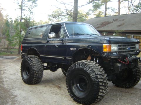 1989 Ford Bronco - This lifted 1989 Ford Bronco features oversized tires and a prominent front grille.