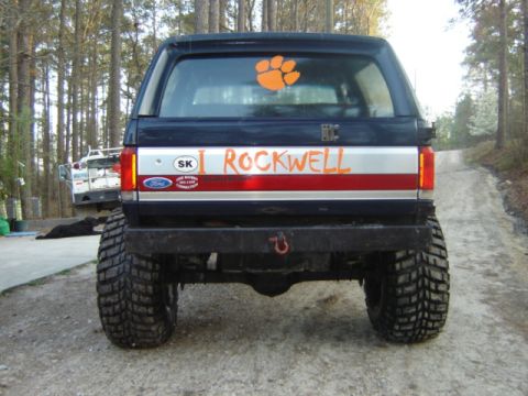 1989 Ford Bronco - This modified Ford Bronco has a custom paint job and decals on its rear. A paw print adorns the back window.