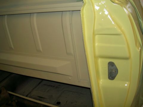 1967 Ford Ranchero - Close-up of a vehicle's interior bed and door jamb, showing painted surfaces and latch hardware.