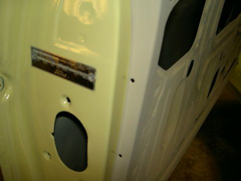 1967 Ford Ranchero - Close-up of a 1967 Ford Ranchero VIN plate on the interior of a yellow door.