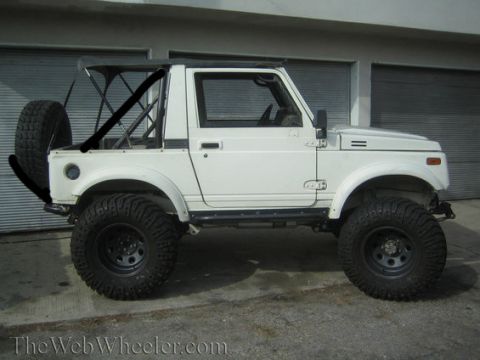 1987 Suzuki Samurai - This 1987 Suzuki Samurai is equipped with large off-road tires and a roll cage.