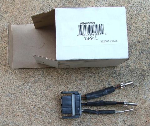 1991 Ford LTD Crown Victoria - An alternator part and its box are shown on a textured surface. The box has a label with a barcode and the text 'Alternator 13-91L'.