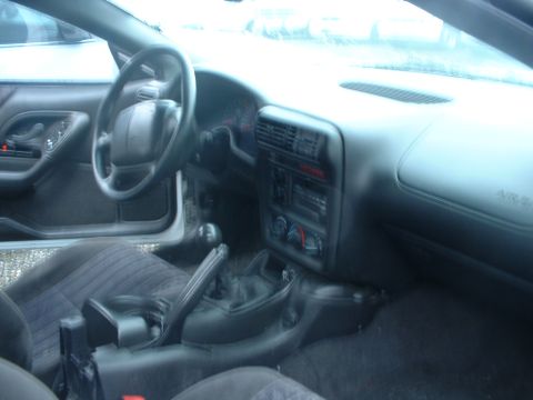 2000 Ford Crown Victoria - The interior of a car is shown, the dashboard, steering wheel, and center console.