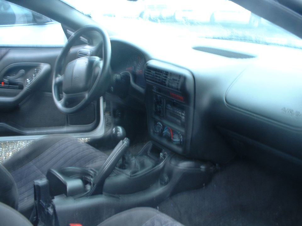 Interior view of a car with a steering wheel and dashboard