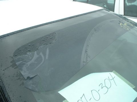 2000 Ford Crown Victoria - The windshield shows signs of wear, with peeling tint and water spots, obscuring the interior view.