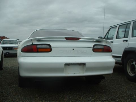 2000 Ford Crown Victoria - Rear view of a white Chevrolet Camaro, identifiable by its taillights and the 'CAMARO' badging.