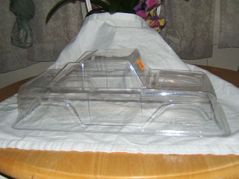 1988 Ford Bronco - Unpainted clear plastic body for an RC crawler, likely a Bronco, shown from the side.