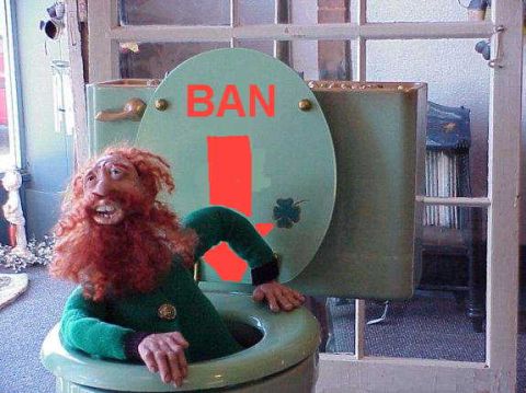1979 Ford Bronco - A leprechaun doll is humorously placed inside a toilet bowl, with a warning sign on the lid.