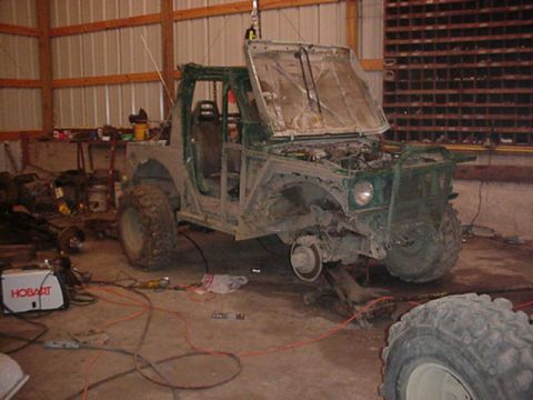 1992 Ford Bronco - This off-road vehicle appears to be undergoing modifications or repairs in a workshop setting.